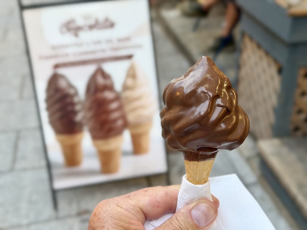 Soft ice cream on a cone dipped in milk chocolate