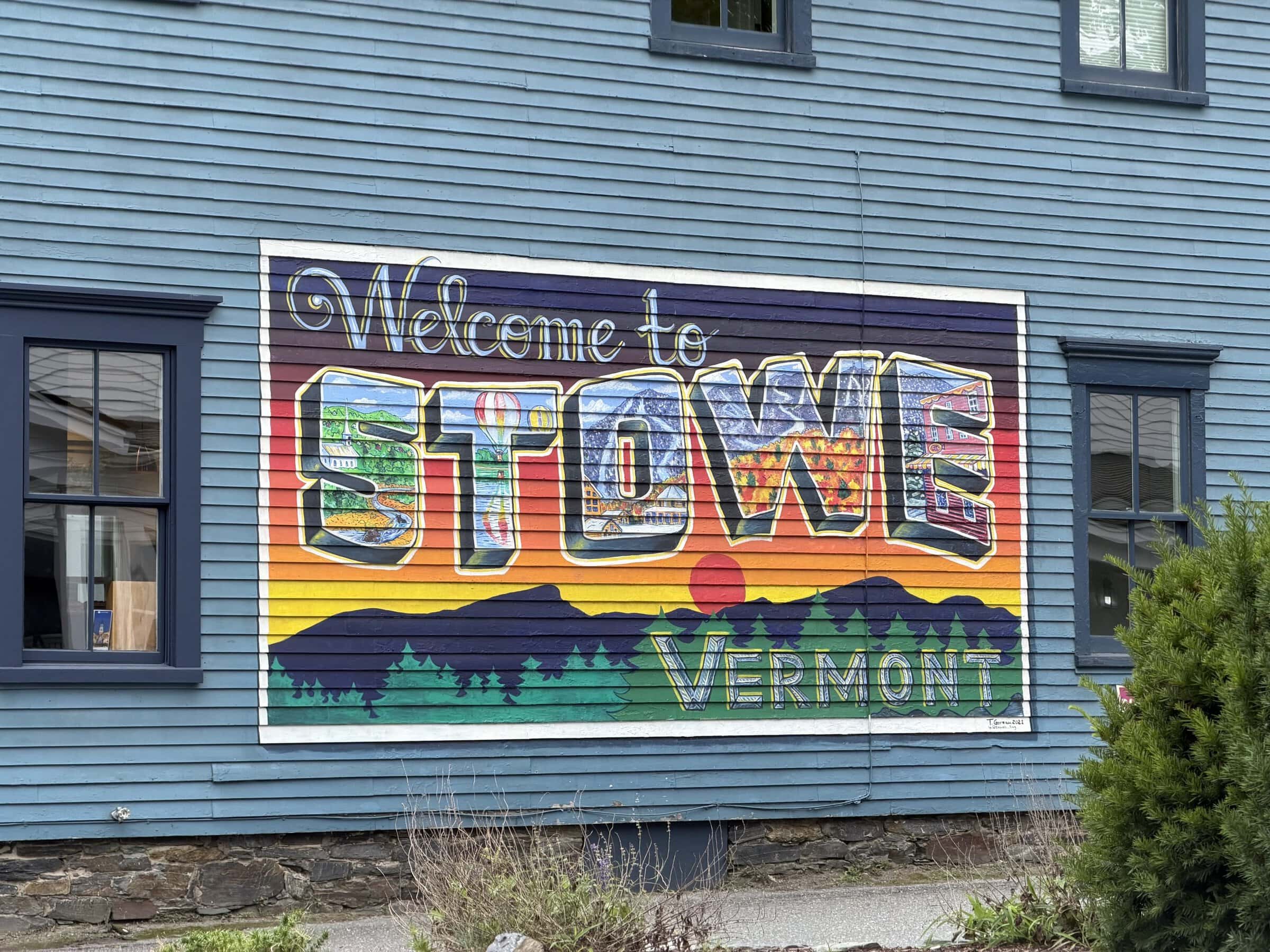 The postcard-looking mural on the side of the grocery store that says "Welcome to Stowe Vermont"